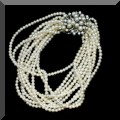 J15. Multi-strand pearl and diamond bracelet. 